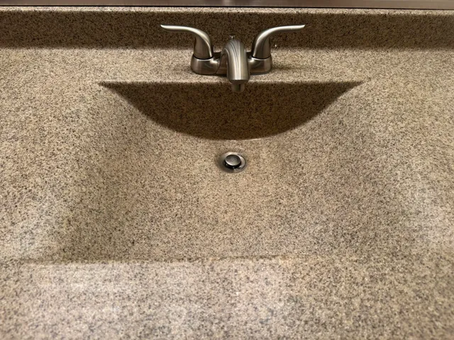 an empty room with wooden floor and cabinet