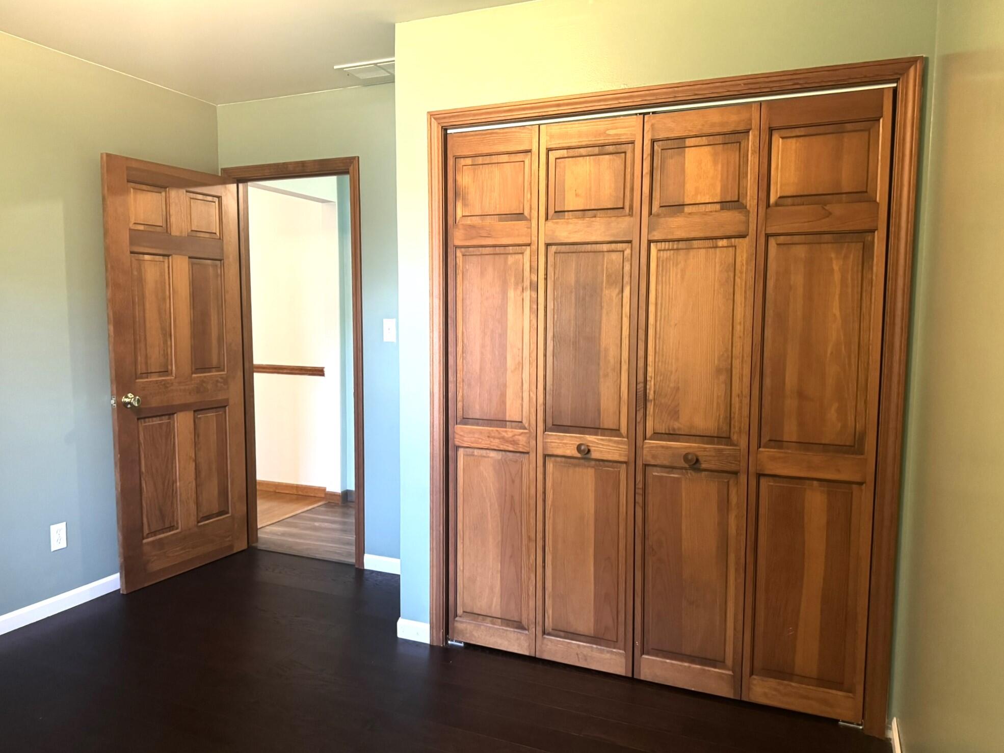 641 D Begonia Street Southeast De Motte, IN 46310 - Photo 35 of 39 an empty room with wooden floor and cabinet