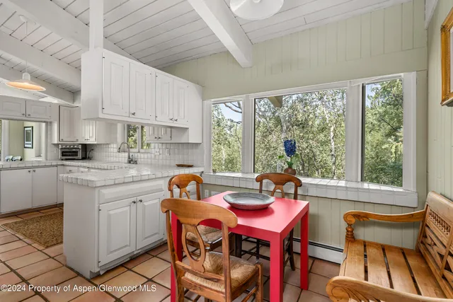 a view of a dining room with furniture window and outside view