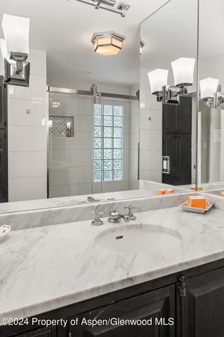 a bathroom with a sink a vanity and a mirror