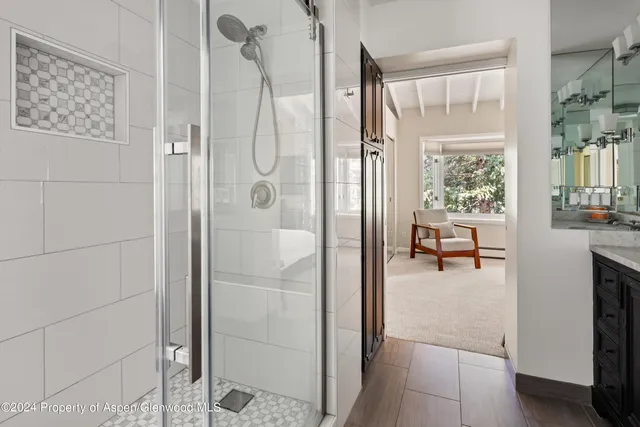 a bathroom with a shower and a sink