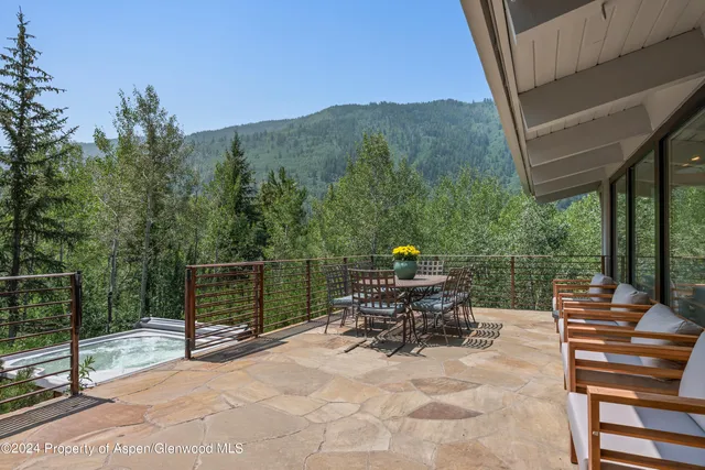a view of chairs and tables in the roof deck