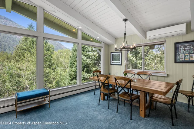 a view of a dining room with furniture window and outside view