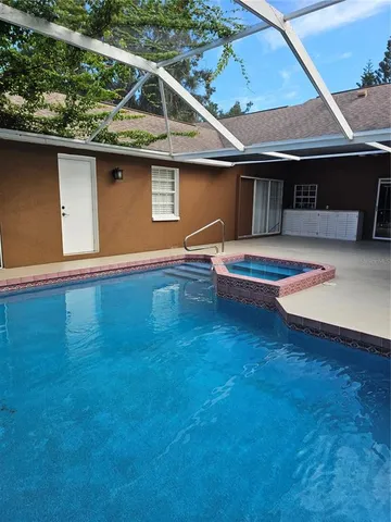 a view of a backyard with swimming pool