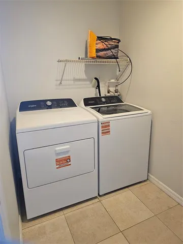 a view of a backyard with pool table and chairs