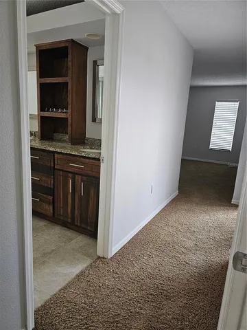 an empty room with windows and ceiling fan