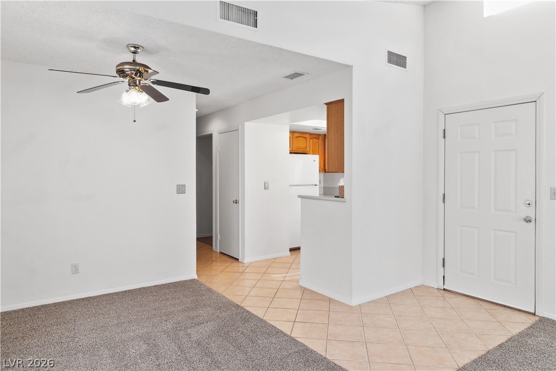 2146 High Dunes Lane Laughlin, NV 89029 - Photo 12 of 64 Dining area featuring light tile patterned floors, baseboards, and ceiling fan