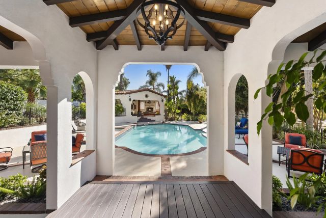 a swimming pool with outdoor seating and yard