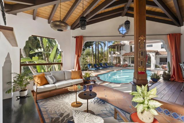 a dining room with furniture a fireplace and wooden floor