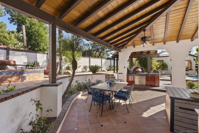 a building outdoor space with patio furniture and potted plants