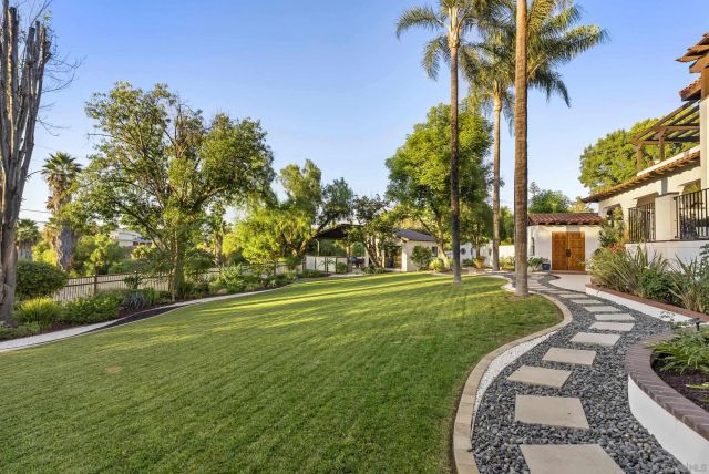 a view of a house with a yard and sitting area