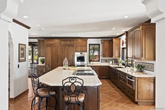 a large kitchen with a table and chairs in it
