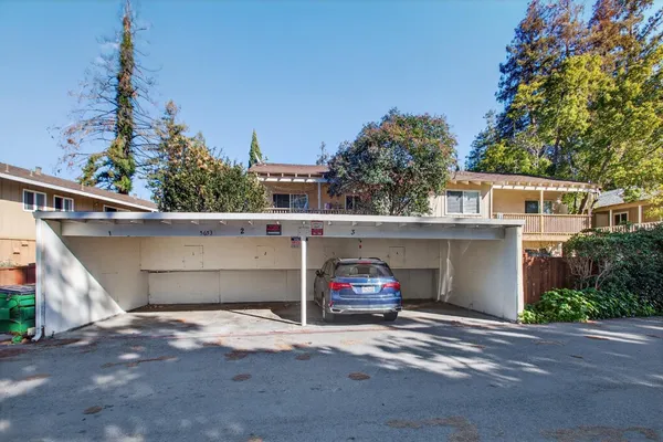 a view of a house with a yard and plants
