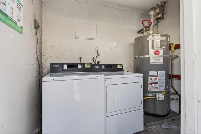 a view of a house with yard and large trees
