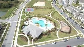 a view of a swimming pool with a yard and plants