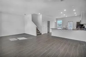 a view of a kitchen with a sink and a refrigerator