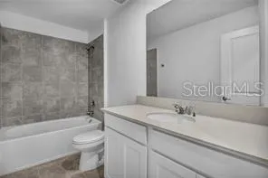 a bathroom with a sink a toilet and bathtub