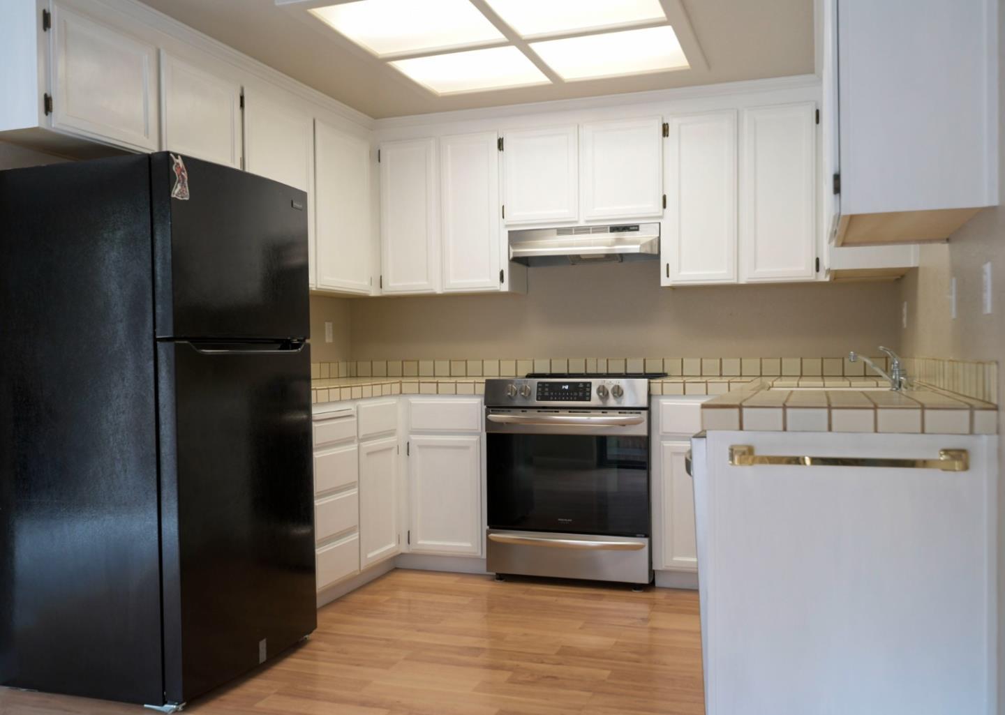 584 Valeri Ruth Court Santa Clara, CA 95050 - Photo 11 of 27 a kitchen with a refrigerator and a stove