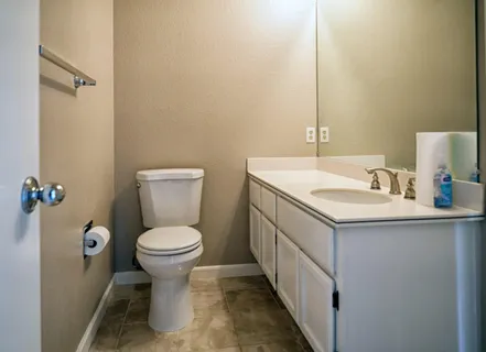 a bathroom with a sink toilet and a mirror