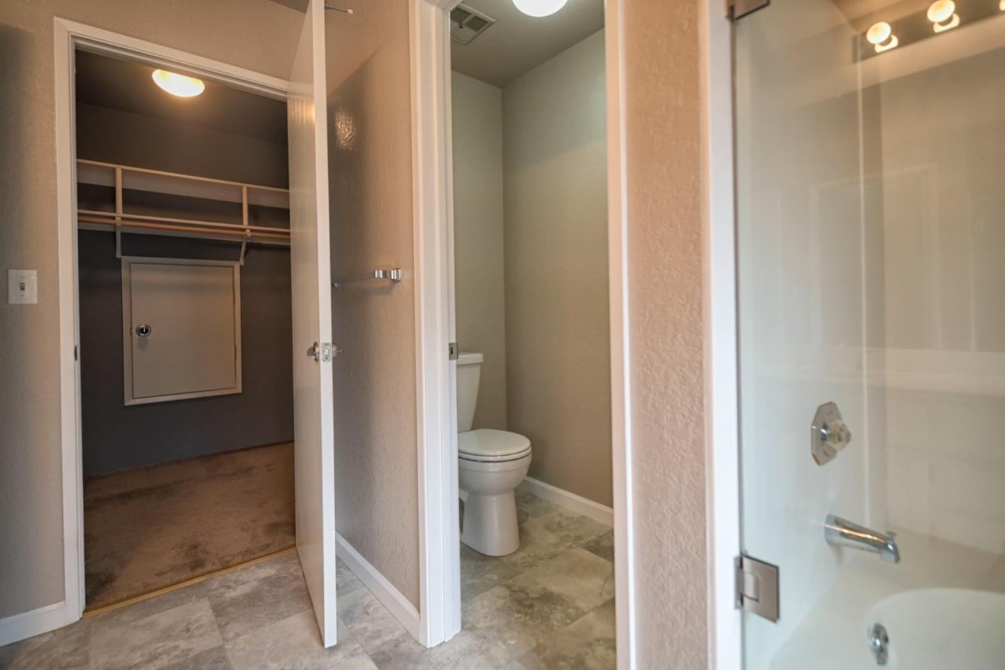 584 Valeri Ruth Court Santa Clara, CA 95050 - Photo 26 of 27 a bathroom with a granite countertop toilet and a shower