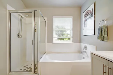 a white bath tub sitting next to a white sink