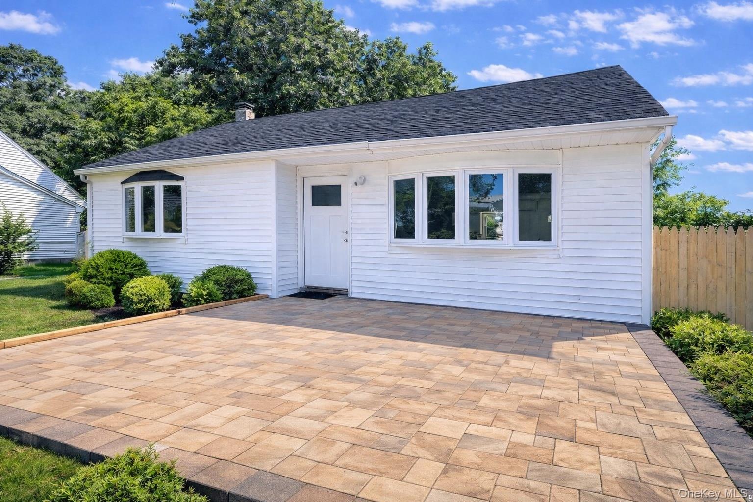 79 Johns Neck Road Shirley, NY 11967 - Photo 1 of 11 a front view of a house with a yard