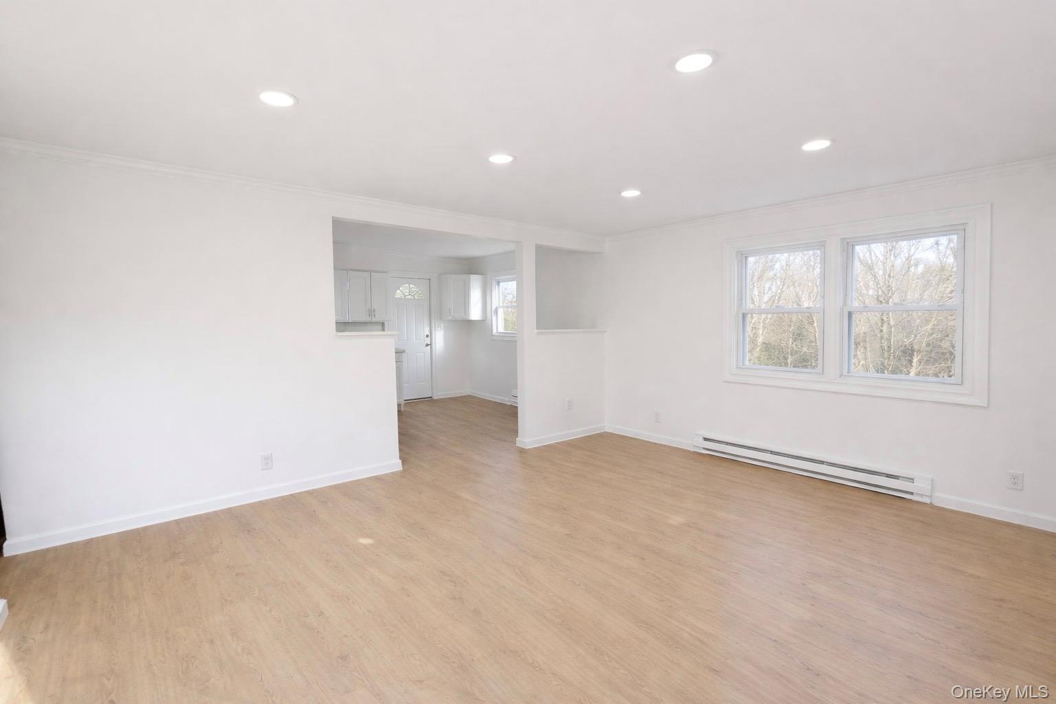 79 Johns Neck Road Shirley, NY 11967 - Photo 2 of 11 an empty room with windows and closet