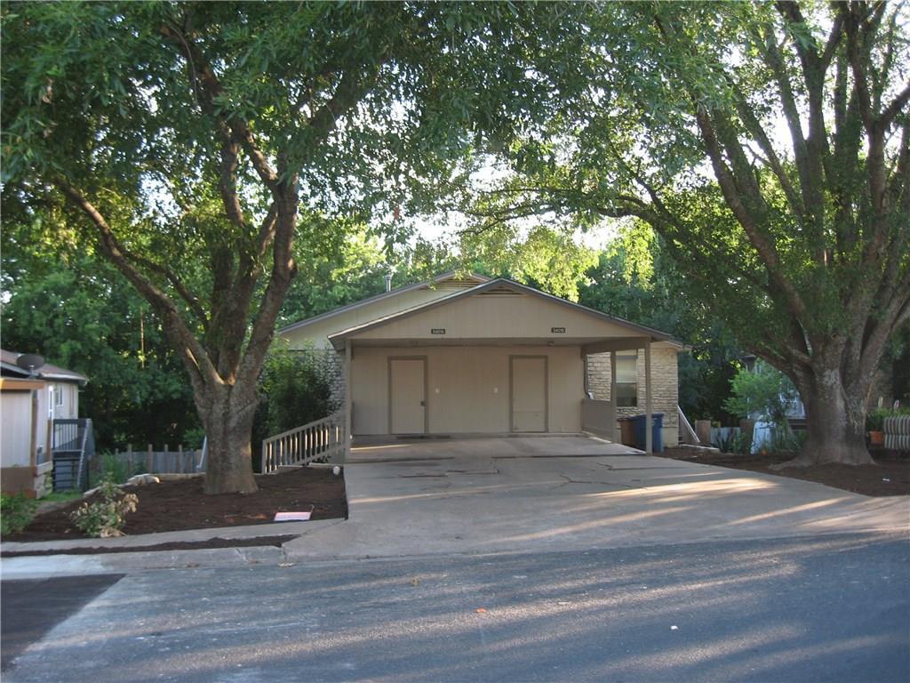 5401 Spring Meadow Road, Unit B Austin, TX 78744 - Photo 20 of 21 A welcoming carport entry is nestled between mature trees, offering ample shade and parking.