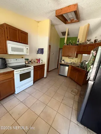 a kitchen with stainless steel appliances a stove a sink and a refrigerator