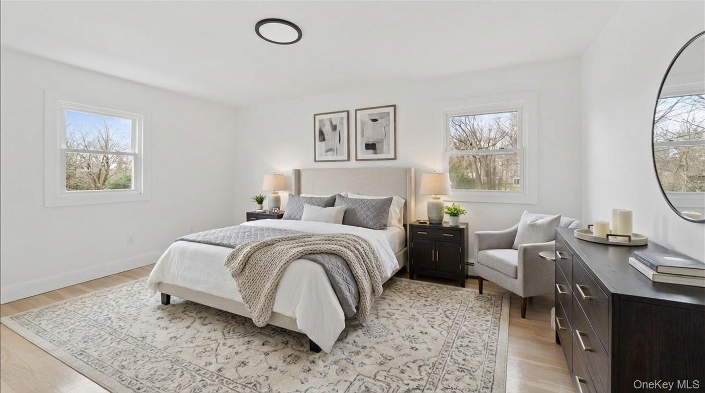 77 Friendly Road Mahopac, NY 10541 - Photo 13 of 36 Staged Primary Bedroom featuring multiple windows and light wood-type flooring