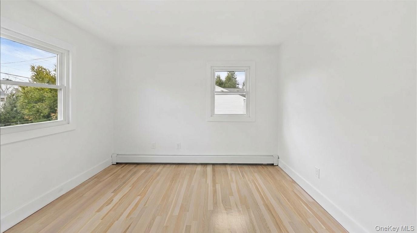 77 Friendly Road Mahopac, NY 10541 - Photo 21 of 36 Spare room featuring light wood-style floors and a baseboard heating unit