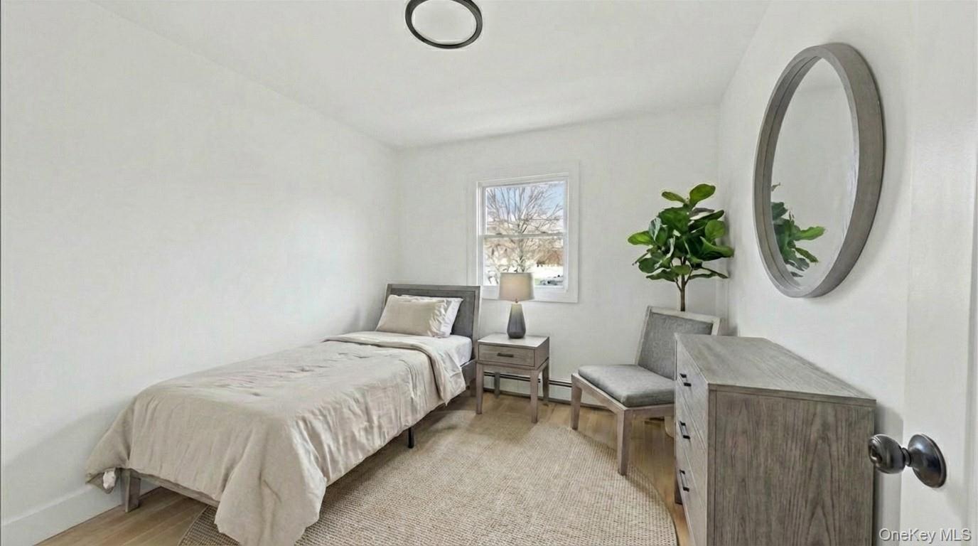 77 Friendly Road Mahopac, NY 10541 - Photo 22 of 36 Staged third bedroom featuring light wood-type flooring and baseboard heating