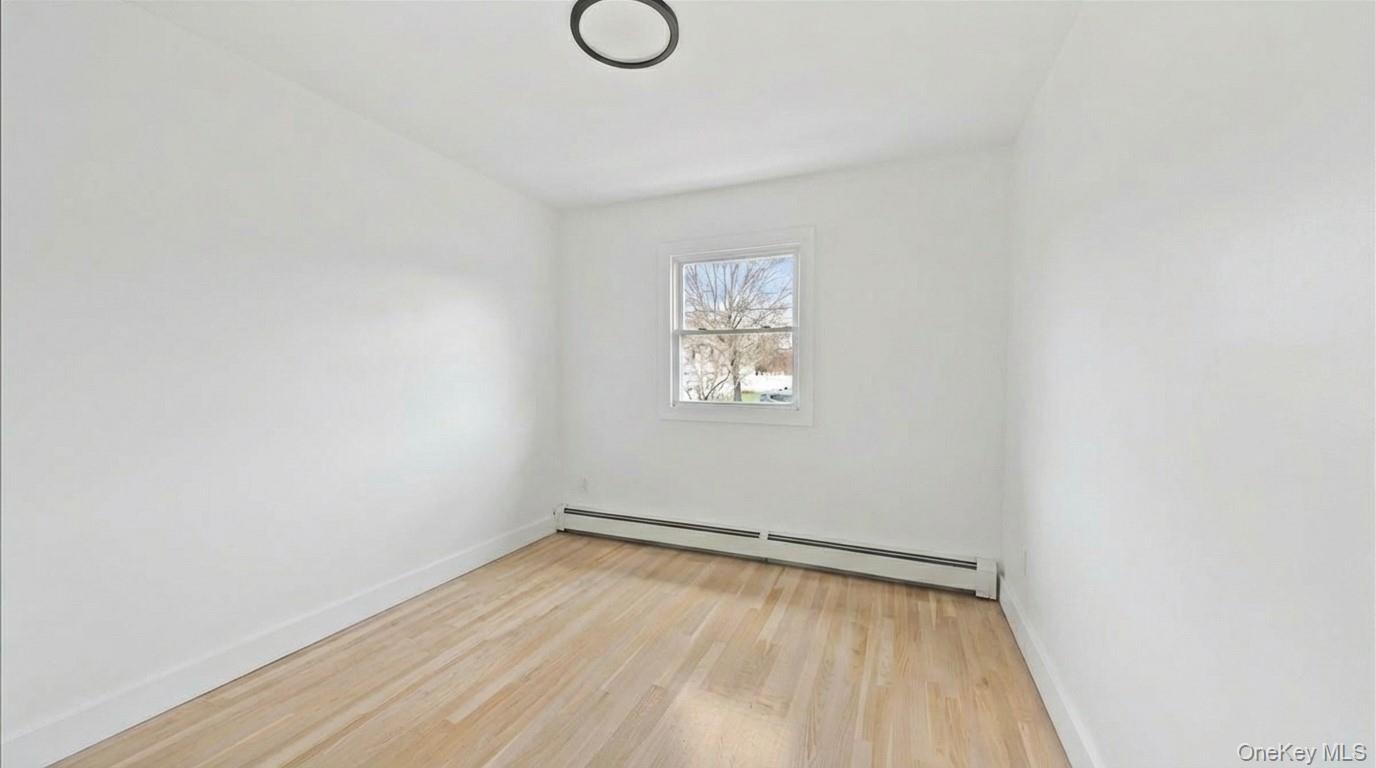 77 Friendly Road Mahopac, NY 10541 - Photo 23 of 36 Third bedroom featuring light wood finished floors and baseboard heating