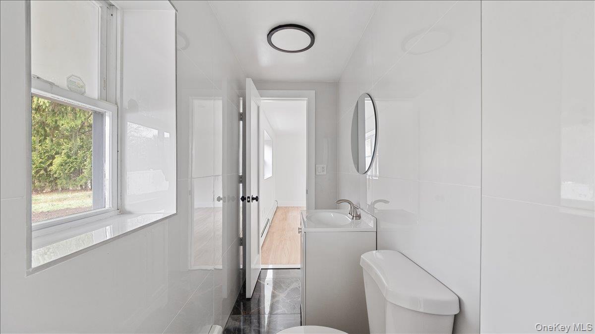 77 Friendly Road Mahopac, NY 10541 - Photo 24 of 36 Basement Bathroom featuring vanity and tile walls