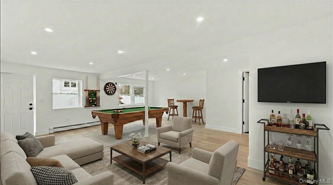 77 Friendly Road Mahopac, NY 10541 - Photo 30 of 36 Staged Family room with billiards, wood finished floors, baseboard heating, recessed lighting, and walk out access.