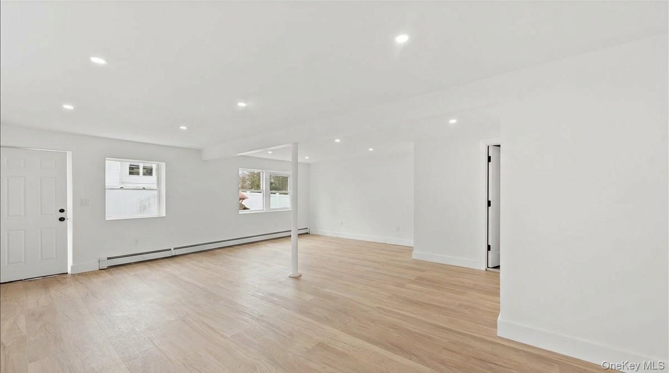 77 Friendly Road Mahopac, NY 10541 - Photo 31 of 36 Basement with a baseboard radiator, light wood-type flooring, recessed lighting, and walk out access.