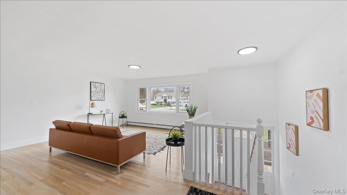 77 Friendly Road Mahopac, NY 10541 - Photo 4 of 36 Sitting room featuring light wood-type flooring, an upstairs landing, and a baseboard radiator