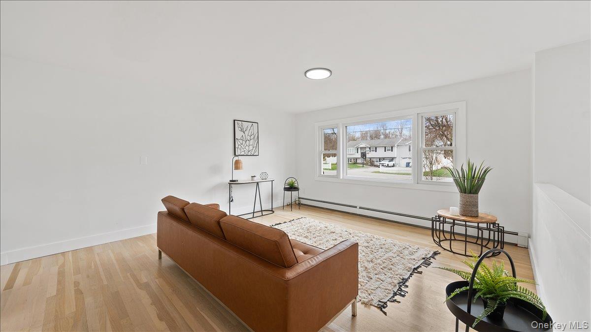 77 Friendly Road Mahopac, NY 10541 - Photo 5 of 36 Sitting room with light wood finished floors and a baseboard radiator