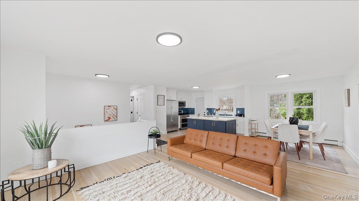 77 Friendly Road Mahopac, NY 10541 - Photo 6 of 36 Living area with light wood-style floors and a baseboard radiator