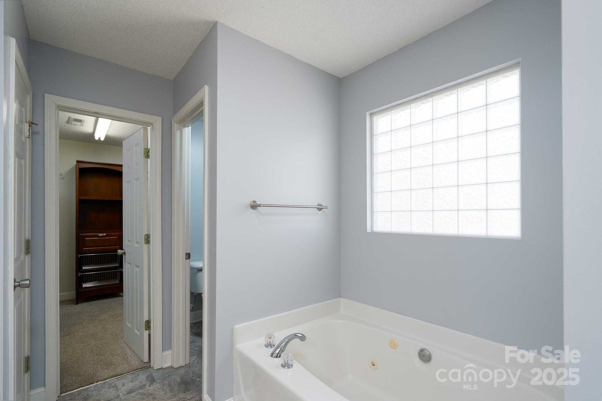 280 Bonaventure Drive Salisbury, NC 28147 - Photo 18 of 48 a white bath tub sitting in a bathroom next to a window