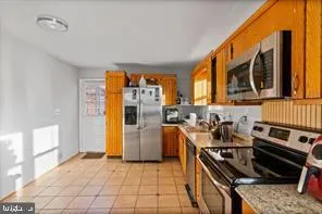 a kitchen with stainless steel appliances granite countertop a stove and a refrigerator