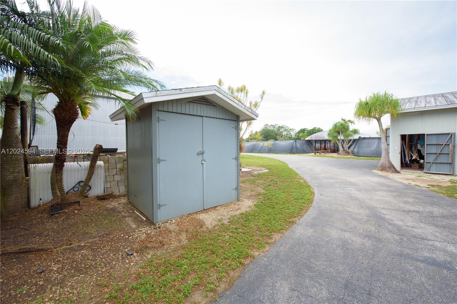 17355 Southwest 256th Street Homestead, FL 33031 - Photo 32 of 32 a view of a house with a yard and garage