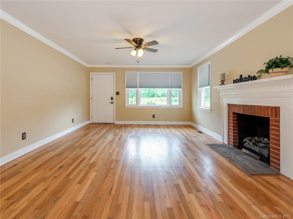 1084 Memorial Park Road Lancaster, SC 29720 - Photo 4 of 24 wooden floor in an empty room with a fireplace
