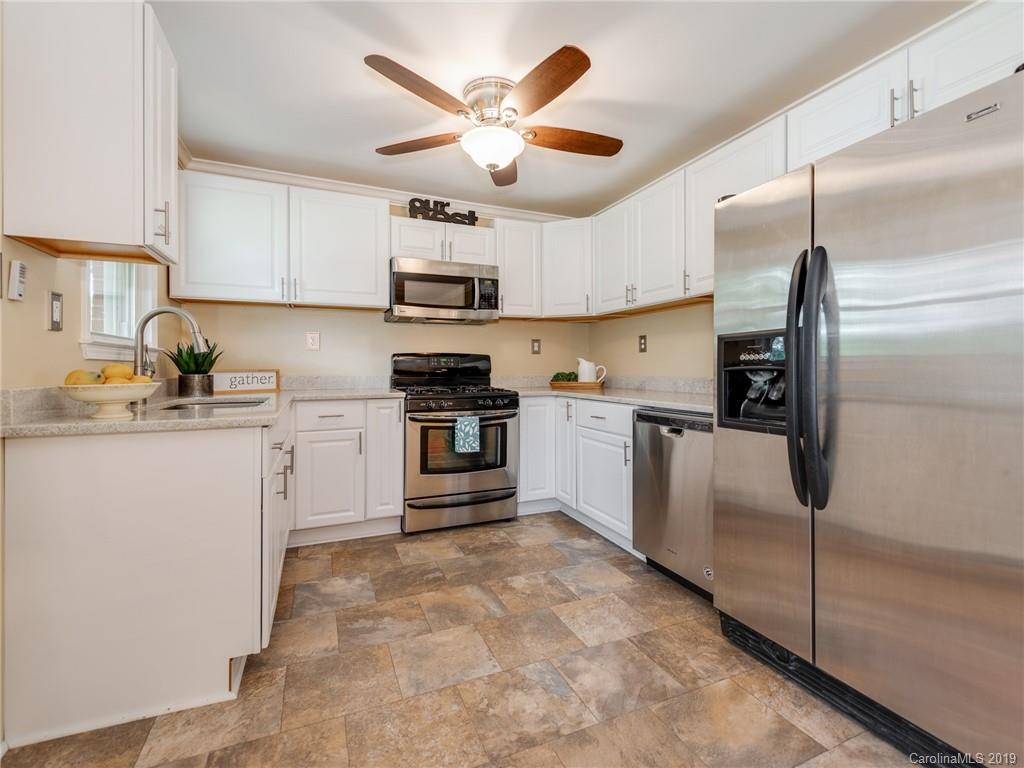 1084 Memorial Park Road Lancaster, SC 29720 - Photo 8 of 24 a kitchen with stainless steel appliances cabinets a sink and a counter top space