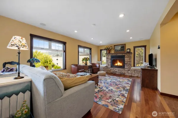 a living room with furniture a fireplace and a flat screen tv