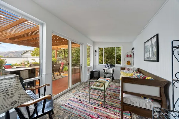 a living room with furniture a rug and a large window