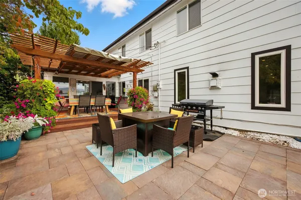 a view of a patio with table and chairs potted plants