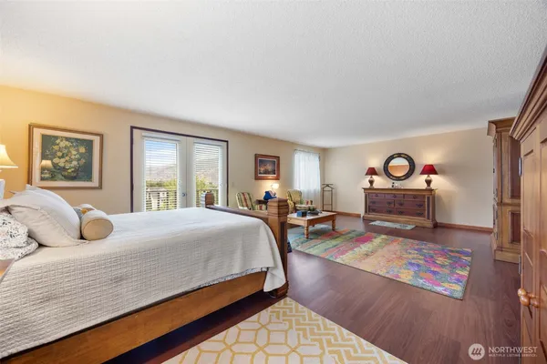 a bedroom with a bed and glass windows