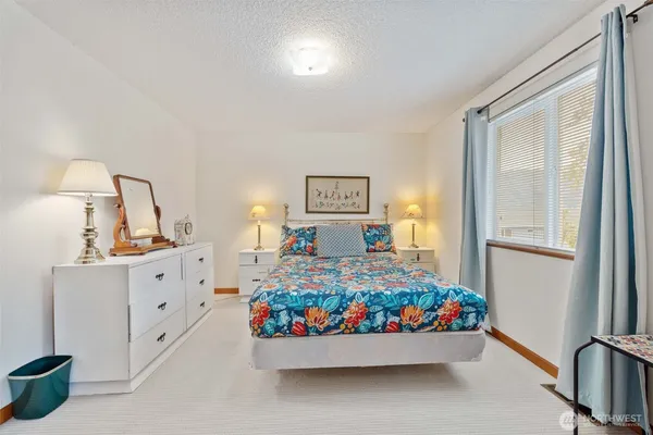 a bedroom with bed and a window
