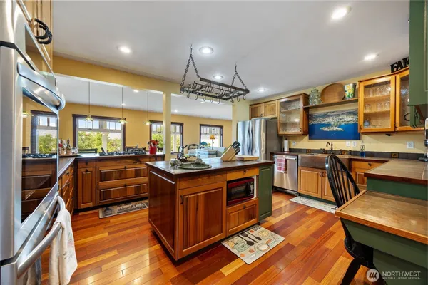 a kitchen with stainless steel appliances granite countertop a stove and a sink
